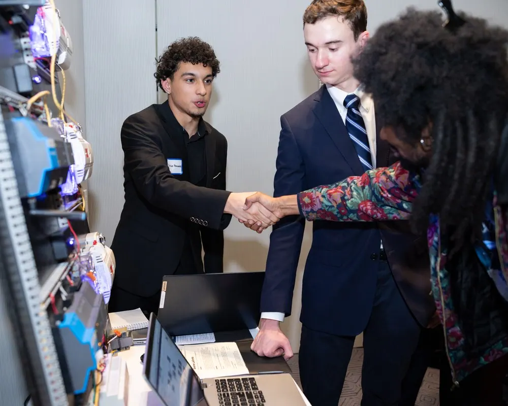 A Stacks+Joules graduate shaking hands with an employer.